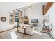 Inviting living room with a cozy fireplace, large windows, and stylish decor at 942 Xenon Ct, Golden, CO 80401