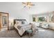 Bright main bedroom with a bay window, bench, and plush carpeting for a cozy feel at 942 Xenon Ct, Golden, CO 80401