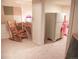 Basement area with desk and vintage refrigerator, a rocking chair, and neutral carpeting at 6588 S Sheridan Loop, Littleton, CO 80123