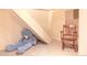 Basement area with stairs and carpet, a rocking chair and a large teddy bear at 6588 S Sheridan Loop, Littleton, CO 80123