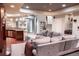 A finished basement with a comfortable seating area, bar with granite counter, and stylish lighting at 6588 S Sheridan Loop, Littleton, CO 80123