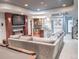 A finished basement with a comfortable seating area, bar with granite counter, fireplace, and stylish lighting at 6588 S Sheridan Loop, Littleton, CO 80123