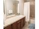 Bathroom featuring a single sink and vanity with a tiled countertop, with a shower and tub at 6588 S Sheridan Loop, Littleton, CO 80123