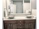 Bathroom vanity with dual vessel sinks, modern fixtures, and a large mirror at 6588 S Sheridan Loop, Littleton, CO 80123