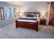 Bedroom with wood bed, window with shutters, and barn door feature at 6588 S Sheridan Loop, Littleton, CO 80123