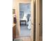 Hallway view into neutral bedroom with a comfortable bed, accent wall, and decorative shelves at 6588 S Sheridan Loop, Littleton, CO 80123