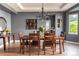 Dining room featuring hardwood floors, modern chandelier, and large windows for natural light at 6588 S Sheridan Loop, Littleton, CO 80123