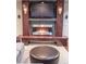 A modern fireplace with mosaic tile, a built-in media center, and stylish lighting. Comfortable seating area at 6588 S Sheridan Loop, Littleton, CO 80123