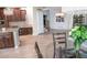 Open kitchen with wood cabinetry and large dining area with lots of light at 6588 S Sheridan Loop, Littleton, CO 80123