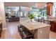 Open floor plan from kitchen to living room; granite island with seating at 6588 S Sheridan Loop, Littleton, CO 80123
