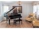 Living area with black grand piano, hardwood floors, and natural light at 6588 S Sheridan Loop, Littleton, CO 80123
