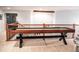 Spacious loft featuring a shuffleboard game table, elegant lighting, and railing with black iron pickets and wood at 6588 S Sheridan Loop, Littleton, CO 80123