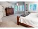 Bright main bedroom with natural light from many windows, wood furniture, and neutral color palette at 6588 S Sheridan Loop, Littleton, CO 80123