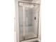 Glass-enclosed shower with a built-in seat and tiled walls in the bathroom at 6588 S Sheridan Loop, Littleton, CO 80123