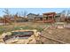 Large backyard features a deck with a pergola, pond, and garden beds, offering outdoor enjoyment at 7074 Yates St, Westminster, CO 80030