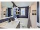 Stylish bathroom features subway tile, a modern vanity, and a shower with a decorative niche at 7074 Yates St, Westminster, CO 80030