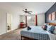 Bedroom with a large bed and ensuite bathroom, featuring natural light and modern fixtures at 7074 Yates St, Westminster, CO 80030