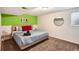 Green accent bedroom featuring a large bed, modern decor, and neutral walls at 7074 Yates St, Westminster, CO 80030