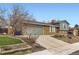 Charming home with attached garage, long driveway, green lawn, and well-maintained landscaping at 7074 Yates St, Westminster, CO 80030