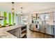 Updated kitchen featuring stainless steel appliances, granite countertops, open layout, and hardwood floors at 7074 Yates St, Westminster, CO 80030