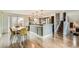 Bright kitchen with modern appliances, breakfast bar, and open dining area at 7074 Yates St, Westminster, CO 80030