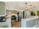 Modern kitchen featuring stainless steel appliances, granite countertops, pendant lighting, and hardwood floors at 7074 Yates St, Westminster, CO 80030