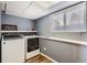 Functional laundry room with modern washer and dryer and ample shelf space for storage at 7074 Yates St, Westminster, CO 80030