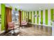 Bright living room featuring hardwood floors, striped accent wall, stylish furnishings, and natural light at 7074 Yates St, Westminster, CO 80030