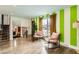 Bright living room featuring hardwood floors, striped accent wall, stylish furnishings, and natural light at 7074 Yates St, Westminster, CO 80030