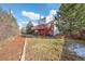 Backyard view featuring grass, mulch, trees, and a wooden deck with stairs at 2043 E Nichols Dr, Centennial, CO 80122