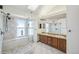 Luxurious bathroom with glass shower, double sinks, a skylight, and updated fixtures at 2043 E Nichols Dr, Centennial, CO 80122