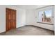 Well-lit bedroom featuring neutral paint, newer carpet, and a large window at 2043 E Nichols Dr, Centennial, CO 80122