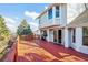 Wooden backyard deck featuring outdoor grill, sliding glass doors, and view of the fenced-in backyard at 2043 E Nichols Dr, Centennial, CO 80122