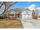 Charming brick home with a two-car garage and well-maintained lawn offers classic curb appeal at 2043 E Nichols Dr, Centennial, CO 80122