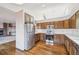 Well-lit kitchen with stainless steel appliances, wooden cabinets and hardwood floors at 2043 E Nichols Dr, Centennial, CO 80122