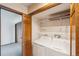 Convenient laundry area with washer, dryer, and built-in shelving at 2043 E Nichols Dr, Centennial, CO 80122