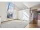 Bright living room with large windows, vaulted ceiling, and hardwood floors at 2043 E Nichols Dr, Centennial, CO 80122