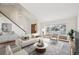 Bright living room featuring a large window, neutral decor, and a staircase at 2043 E Nichols Dr, Centennial, CO 80122