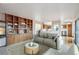 Cozy living room with built-in shelving, comfortable seating, and view into the kitchen at 2043 E Nichols Dr, Centennial, CO 80122