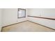 An upstairs carpeted loft area featuring a window and trimmed flooring at 2043 E Nichols Dr, Centennial, CO 80122