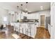 Modern kitchen featuring white cabinets, granite countertops, and a breakfast bar at 9769 W Stanford Ave, Denver, CO 80123