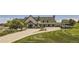 Exterior view of a golf clubhouse with well-manicured landscaping and golf carts at 2162 S Gold Bug Way, Aurora, CO 80018