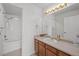 Bathroom with tub and shower combination, tile floors, and vanity at 19663 E Mann Creek Dr # D, Parker, CO 80134