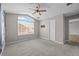 This bedroom has a large window providing natural light and a ceiling fan at 19663 E Mann Creek Dr # D, Parker, CO 80134