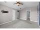 Bright bedroom with a view of the bathroom, two closets, and a ceiling fan at 19663 E Mann Creek Dr # D, Parker, CO 80134