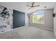 Primary bedroom with floral wallpaper, large window, and ceiling fan at 19663 E Mann Creek Dr # D, Parker, CO 80134