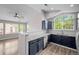 Modern kitchen featuring navy cabinets, granite countertops, stainless steel appliances, and an open layout at 19663 E Mann Creek Dr # D, Parker, CO 80134