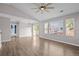 Bright and airy living room with hardwood floors, leading to a balcony through sliding glass doors at 19663 E Mann Creek Dr # D, Parker, CO 80134