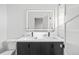 Bathroom featuring dual sinks, lighted mirror, and modern fixtures at 1256 Yates St, Denver, CO 80204