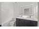 Modern bathroom with a double sink vanity, illuminated mirror, and contemporary fixtures at 1256 Yates St, Denver, CO 80204
